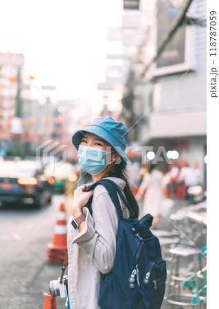 Vertical portrait asian woman backpack traveler wear face mask at Bangkok city 118787059