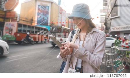 Young adult asian woman traveler backpack in southeast asia chinatown wear hat at outdoor on day Young adult asian woman traveler backpack in southeast asia chinatown wear hat at outdoor on day 118787063