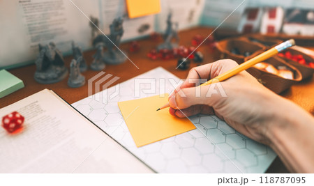 Woman hand writing for create story setup adventure role playing tabletop and board games hobby Woman hand writing for create story setup adventure role playing tabletop and board games hobby 118787095