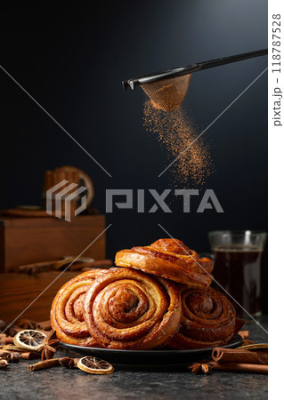 Kanelbullar. Freshly baked buns sprinkled with cinnamon. 118787528