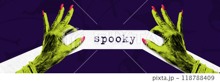 Green witch hands with pink nails holding ribbon labeled spooky against dark purple background. Creative collage. Green witch hands with pink nails holding ribbon labeled spooky against dark purple background. Creative collage. 118788409
