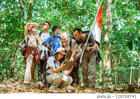 young asian traveler explore forest searching route 118788741