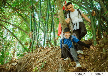 female hijab traveler climbing down mountain male friends 118788742