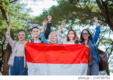 young students holding indonesian flag celebrating independence day 118788792
