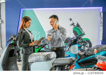 electric bicycle store staff working using tablet phone electric bicycle store staff working using tablet phone 118788830