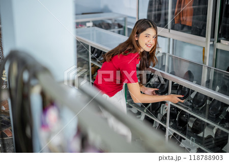high angle view asian female staff arrange leather shoes 118788903