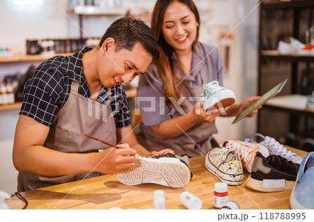 asian male hold brush for paint on shoe asian male hold brush for paint on shoe 118788995