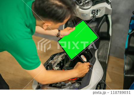 asian male holding copy space tablet fixing bike 118789031