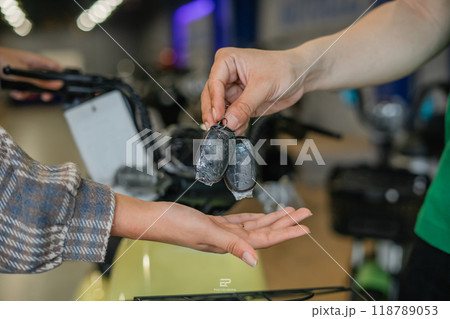 salesman hand over new key female customer salesman hand over new key female customer 118789053