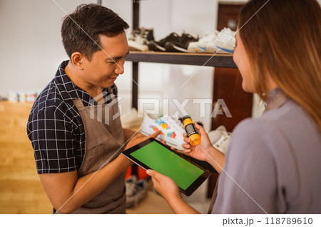 male staff checking paint product on tablet 118789610