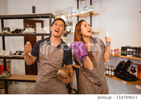 workers standing with holding shoes cleaning tools workers standing with holding shoes cleaning tools 118789621