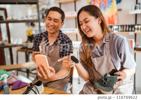 happy workers laughing at something on the phone happy workers laughing at something on the phone 118789622