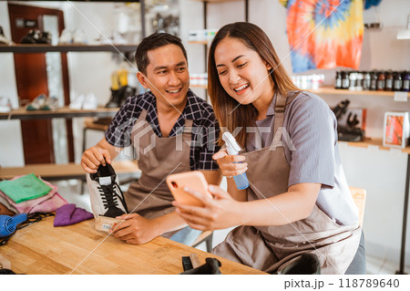 female employee holding and watching phone 118789640