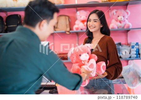 Beautiful girl is gifted a doll by her boyfriend Beautiful girl is gifted a doll by her boyfriend 118789740