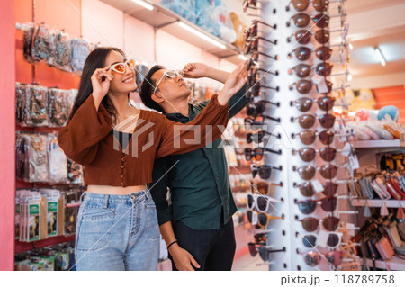 attractive woman and handsome Asian man wearing glasses 118789758