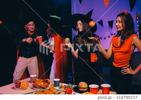 Joyful office Halloween party with coworkers in costumes, celebrating with drinks and laughter, fostering teamwork and festive spirit Joyful office Halloween party with coworkers in costumes, celebrating with drinks and laughter, fostering teamwork and festive spirit 118790237