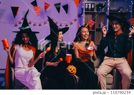 Joyful office Halloween party with coworkers in costumes, celebrating with drinks and laughter, fostering teamwork and festive spirit Joyful office Halloween party with coworkers in costumes, celebrating with drinks and laughter, fostering teamwork and festive spirit 118790239