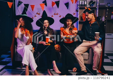 Joyful office Halloween party with coworkers in costumes, celebrating with drinks and laughter, fostering teamwork and festive spirit 118790241