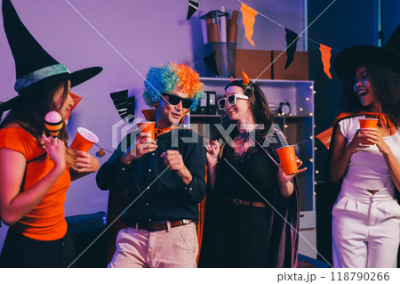 Joyful office Halloween party with coworkers in costumes, celebrating with drinks and laughter, fostering teamwork and festive spirit 118790266
