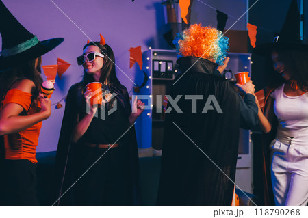 Joyful office Halloween party with coworkers in costumes, celebrating with drinks and laughter, fostering teamwork and festive spirit 118790268