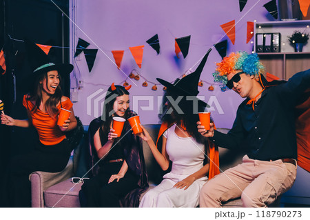 Joyful office Halloween party with coworkers in costumes, celebrating with drinks and laughter, fostering teamwork and festive spirit Joyful office Halloween party with coworkers in costumes, celebrating with drinks and laughter, fostering teamwork and festive spirit 118790273
