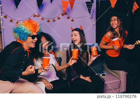 Joyful office Halloween party with coworkers in costumes, celebrating with drinks and laughter, fostering teamwork and festive spirit Joyful office Halloween party with coworkers in costumes, celebrating with drinks and laughter, fostering teamwork and festive spirit 118790276