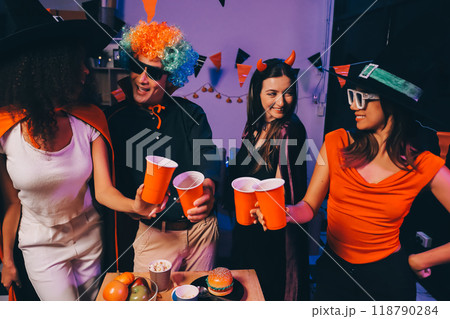 Joyful office Halloween party with coworkers in costumes, celebrating with drinks and laughter, fostering teamwork and festive spirit 118790284