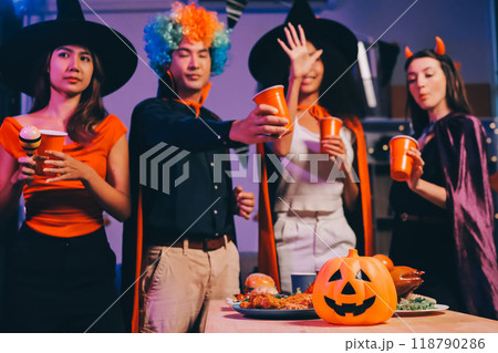 Joyful office Halloween party with coworkers in costumes, celebrating with drinks and laughter, fostering teamwork and festive spirit 118790286