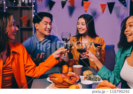 Joyful office Halloween party with coworkers in costumes, celebrating with drinks and laughter, fostering teamwork and festive spirit 118790292