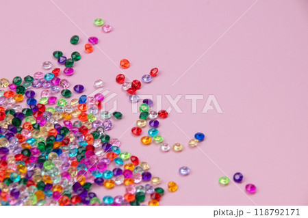 Multicolored tiny faceted crystals on a pink background, beautiful colorful texture 118792171