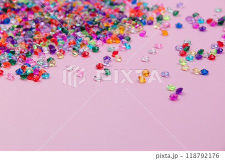 Multicolored tiny faceted crystals on a pink background, beautiful colorful texture Multicolored tiny faceted crystals on a pink background, beautiful colorful texture 118792176