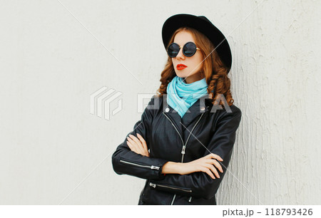 Fashion portrait pretty woman wearing black rock jacket, hat over white background profile view Fashion portrait pretty woman wearing black rock jacket, hat over white background profile view 118793426