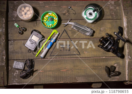 Fishing items on a wooden box. Tools for fishing. Preparing for fishing. Copy space. Hobbies and entertainment. Fishing items on a wooden box. Tools for fishing. Preparing for fishing. Copy space. Hobbies and entertainment. 118798655