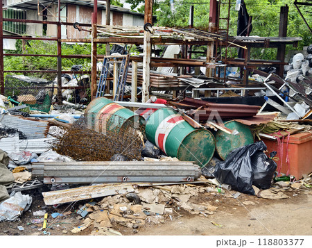 A pile of garbage with a bucket, rope, bottles, and other items at a landfill A pile of garbage with a bucket, rope, bottles, and other items at a landfill 118803377