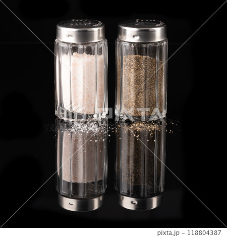 Salt and pepper shaker isolated on black background Salt and pepper shaker isolated on black background 118804387