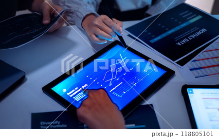 close up hand team of financial discussion fintech  technology planning, analyzing digital financial data and strategy in a modern office at night 118805101