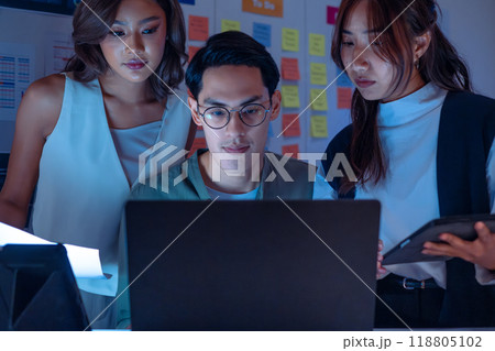 team of financial discussion budget planning, analyzing digital financial data and strategy in a modern office at night 118805102
