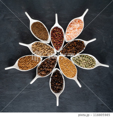 Spices in white porcelain bowls on a slate plate Spices in white porcelain bowls on a slate plate 118805985
