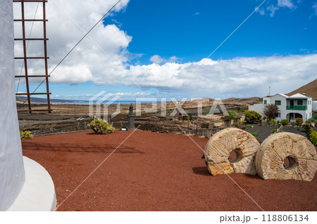 View past the windmill into the vast volcanic landscape in the cactus garden Jardin de Cactus of Lanzarote 118806134