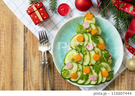 New year meal idea Christmas tree from a salad olivier on a rustic table. 118807444