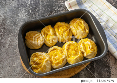 Instruction step 10. Freshly baked pumpkin cinnamon rolls or cinnabon with cream cheese on a rustic wooden table. Homemade seasonal autumn homemade pastry. Instruction step 10. Freshly baked pumpkin cinnamon rolls or cinnabon with cream cheese on a rustic wooden table. Homemade seasonal autumn homemade pastry. 118807579