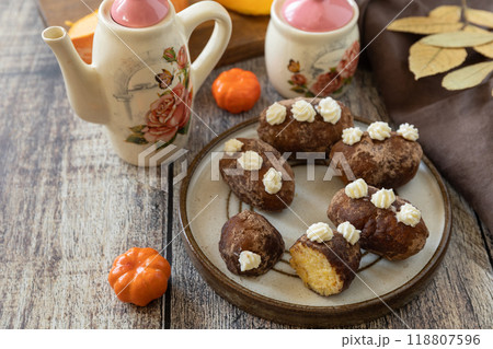 Chocolate rum potato cake with pumpkin on rustic background, homemade vegan dessert. Traditional Eastern European dish with cocoa and butter. Chocolate sweets filled with marzipan. Copy space. Chocolate rum potato cake with pumpkin on rustic background, homemade vegan dessert. Traditional Eastern European dish with cocoa and butter. Chocolate sweets filled with marzipan. Copy space. 118807596