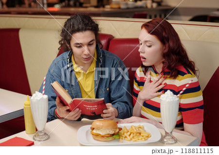Discussing Book in Diner Booth with Food and Milkshakes Discussing Book in Diner Booth with Food and Milkshakes 118811115