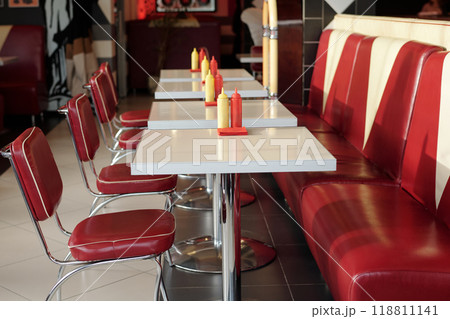 Empty Retro Diner Featuring Red Leather Seating and White Tables Empty Retro Diner Featuring Red Leather Seating and White Tables 118811141