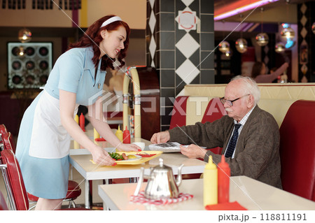 Waitress Serving Food in Retro Diner Setting 118811191