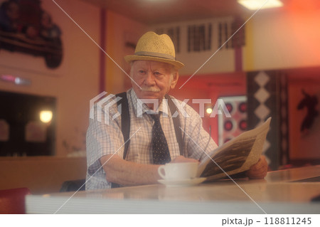 Reading Newspaper at Cafe Counter in Cozy Ambiance 118811245