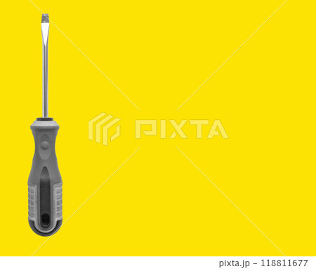 Carpenter holding screwdriver, tool for repair and maintenance. Yellow background with space for Carpenter holding screwdriver, tool for repair and maintenance. Yellow background with space for 118811677