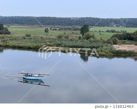 Lonely small boat in the river, shot in the air from hill in Lithuania, quit day, aerial 118812463