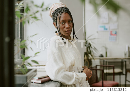 Confident African American businesswoman posing for portrait in office Confident African American businesswoman posing for portrait in office 118813212
