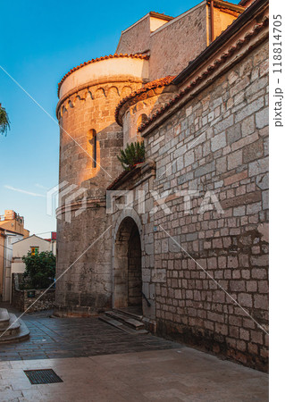 Krk Croatia 28.06.24A quiet street at dawn near an old church 118814705